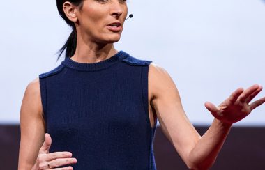 Dr. Lisa Genova stands on stage at a TED conference