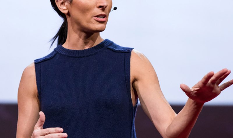 Dr. Lisa Genova stands on stage at a TED conference