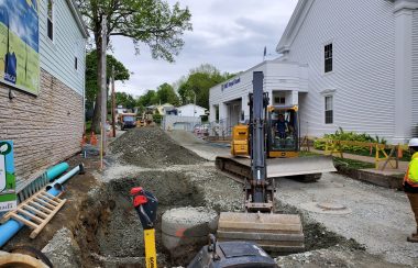 Heavy equipment being used to dig up a road