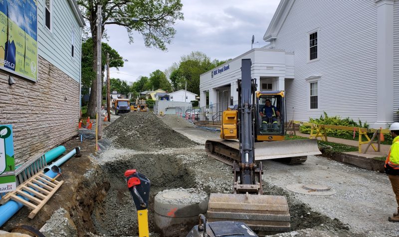 Heavy equipment being used to dig up a road