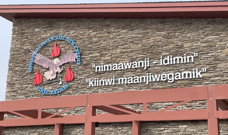 Building with indigenous wording and Mississaugas of the Credit First Nation logo on exterior of Community Centre