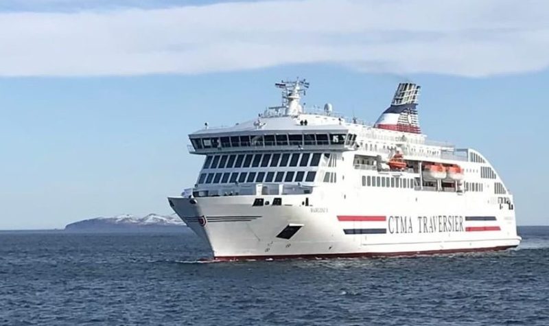 The large, white Madeleine II ferry is seen on the water on a sunny day