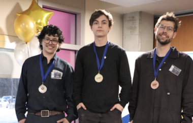 The three medalists standing on their respective podiums with their medals hanging around their necks.