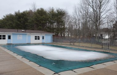 Ice covers the surface of an outdoor pool