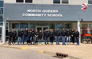 Students lined up in front of the entrance to North Queens Community School