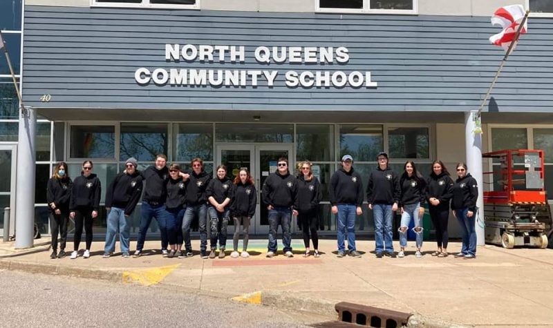 Students lined up in front of the entrance to North Queens Community School