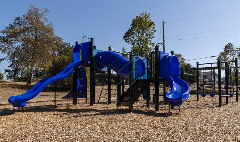 Photo of a playground strucutre with blue slides
