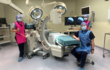 An operating room with 3 healthcare professionals