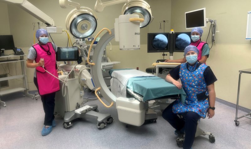 An operating room with 3 healthcare professionals