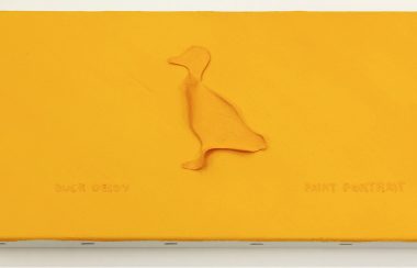 A photo of a canvas covered in yellow, with a yellow duck silhouette in the centre.