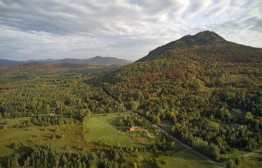 Pictured is an aerial view shot of Owl's Head in Potton with early fall foliage.