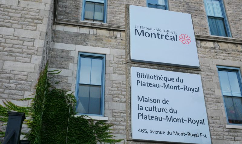 A sign before a stone building facade shows the Maison de la culture du Plateau-Mont-Royal