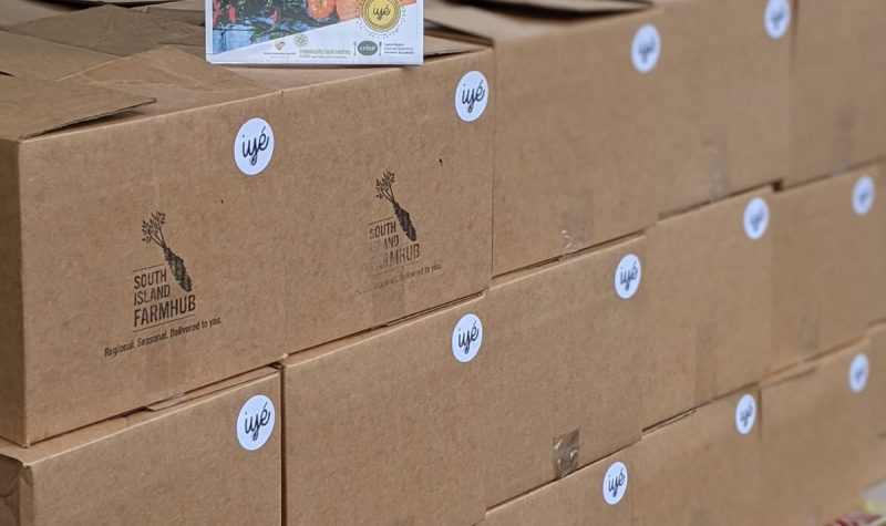 Picture showing food boxes containing freshly-farmed produce to be delivered to some members of the black community in Victoria B.C.