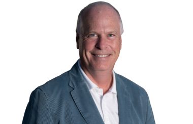 Rick Perkins in a professional headshot against a white background.