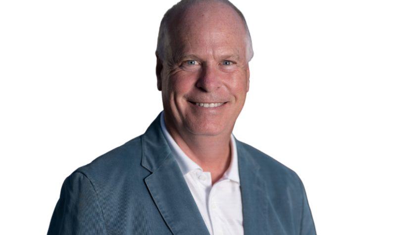 Rick Perkins in a professional headshot against a white background.