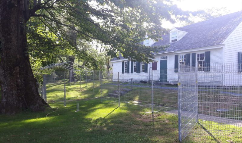 A photo of the construction fence around Perkins House.