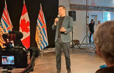 Pierre Pollieve speaking to a crowd in Smithers