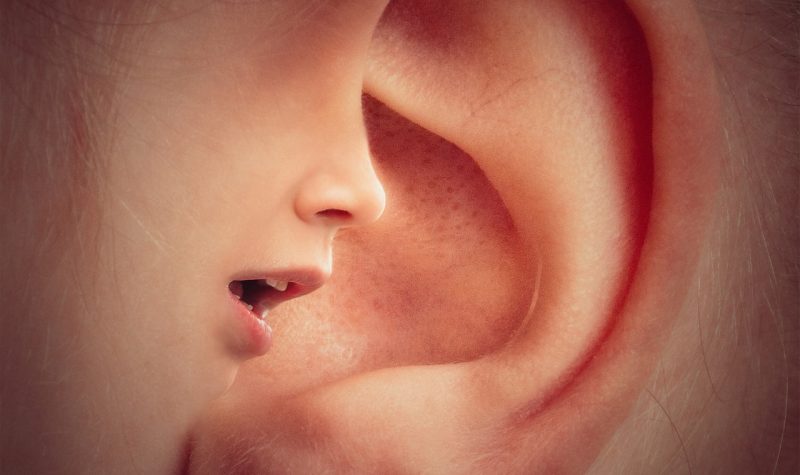a young boy's mouth is juxtaposed over an ear