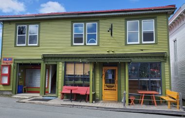 The green exterior of the Port Grocer in Port Medway on a sunny day