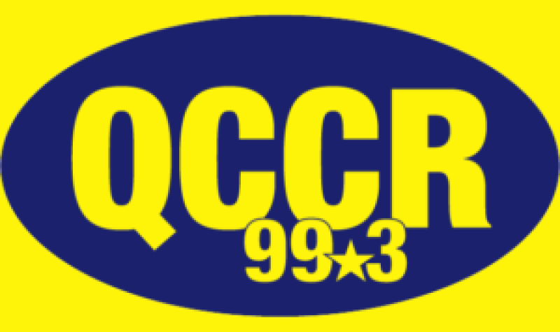 A blue oval with the letters QCCR 99.3 on a yellow background.
