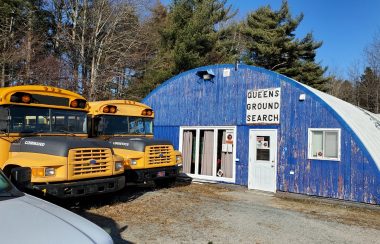 Two school buses parked outside Queens Ground Search and Rescue building