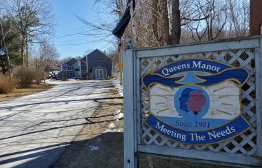 Entrance sign at the end of the driveway to Queens Manor