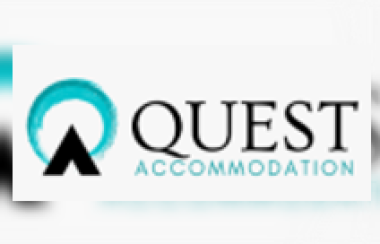 The blue and white Quest Accommodation logo.