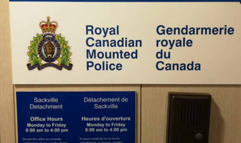 RCMP signs on a wall outside a station office.
