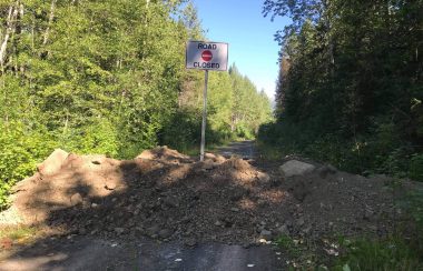 A sign in the woods shows that Suskwa is closed at 18km