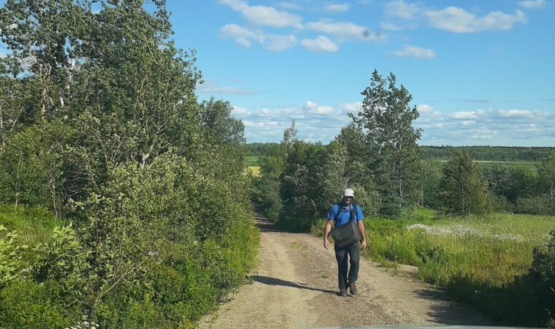 Rory Fraser walking along a dirt road in the distance.