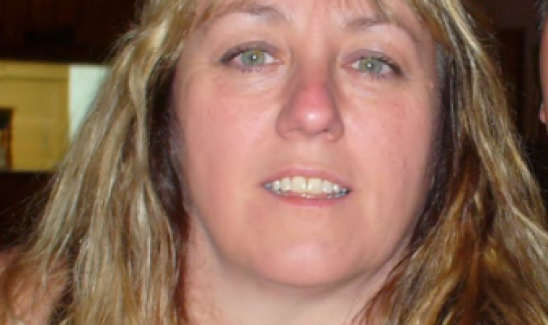 A headshot of Rosalee Gravelle with blonde hair and a black and white top.