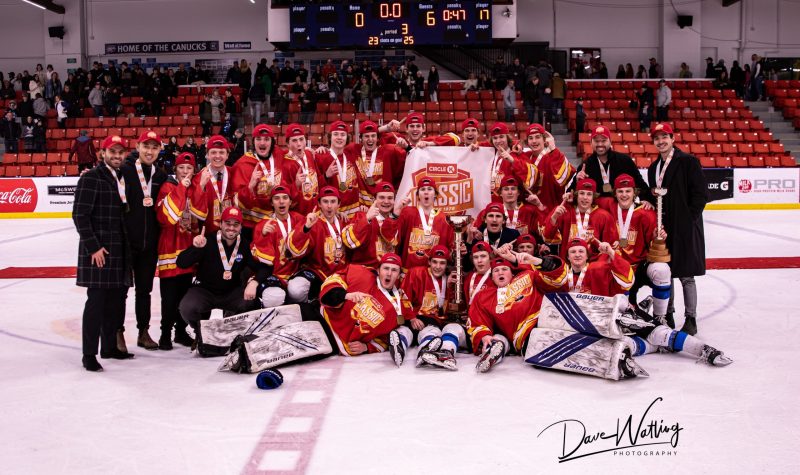 The South Alberta Hockey Academy lay on center ice, posing with the championship they just won at the Circle K Classic