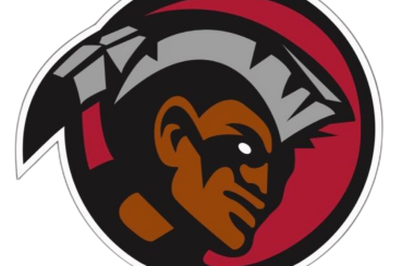 Six Nations Rivermen team logo. A portrait of a man in a red circle with grey hair and a grey feather on the back of the head.