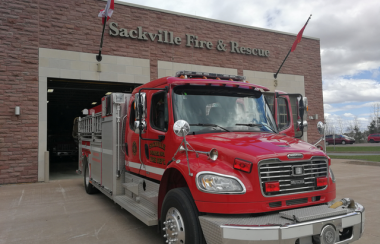 A red fire truck is parked outside of the Sackville Fire and Rescue building.