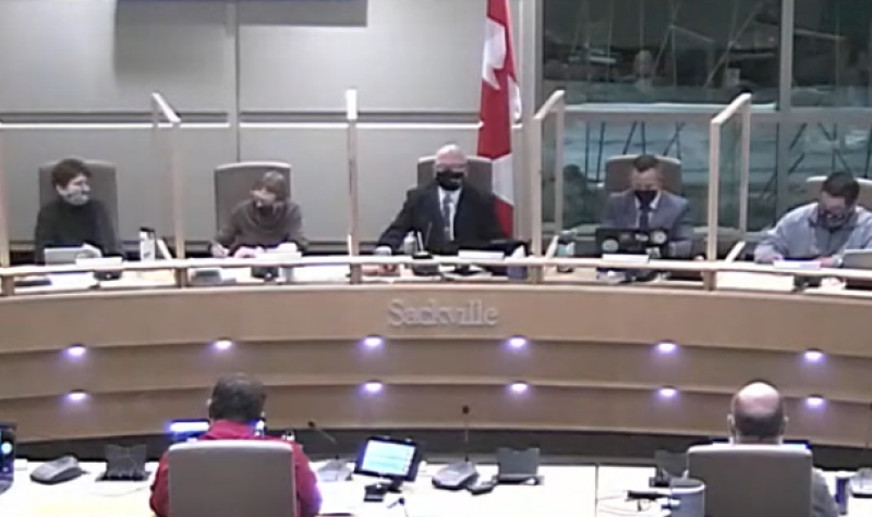 Men and women sitting at a council table, facing the camera.