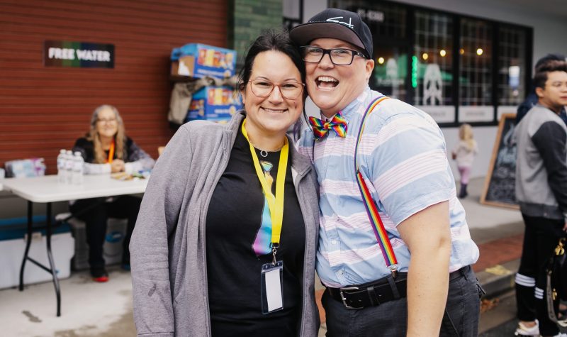 A press photo of Teri Westerby at a PRIDE event in Chilliwack posing with a member of the Chilliwack PRIDE society