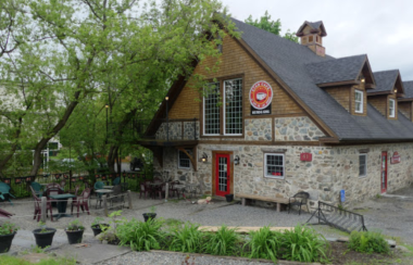 A picture of the outside of the old historic rock building The Star Cafe occupies. The building is situated beside the river.