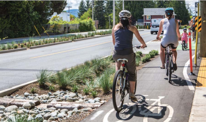 A photo of two people biking outdoors taken from a City of Courtney report.