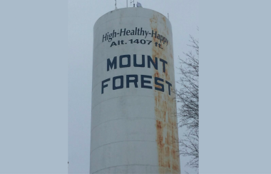 The Mount Forest water tower proudly displays the town's slogan, 'High-Healthy-Happy.'