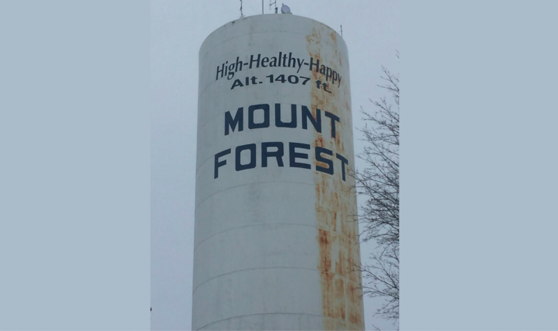 The Mount Forest water tower proudly displays the town's slogan, 'High-Healthy-Happy.'