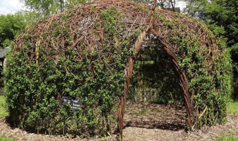 Pictured is the poem cocoon. It is a round structure made out of branches and willow trees.