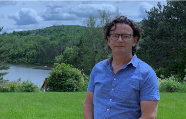 Pictured is president Pierre St-Arnault with greenery and the lake serving as the background.