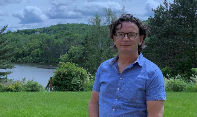 Pictured is president Pierre St-Arnault with greenery and the lake serving as the background.