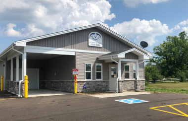 Wide shot of the front of the food Bank building on a sunny day.