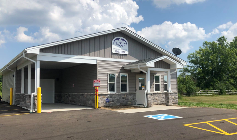 Wide shot of the front of the food Bank building on a sunny day.