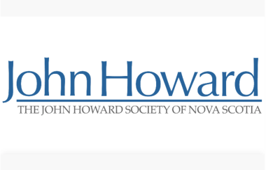 Photo of a logo that says John Howard Society of Nova Scotia in blue letters. The background is white.