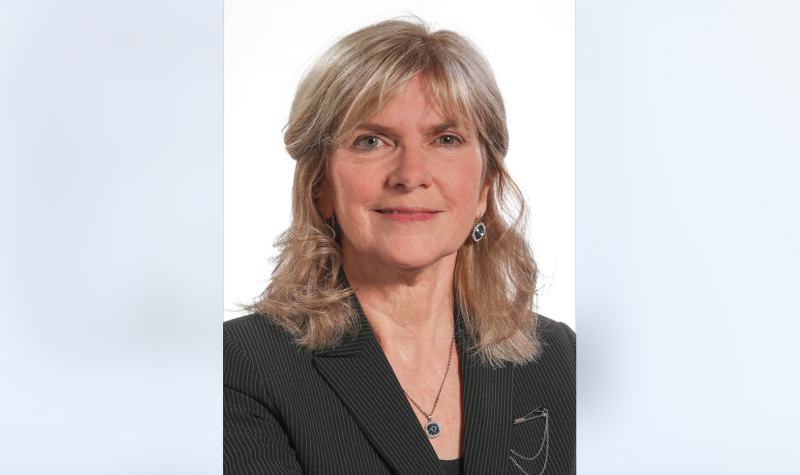 Portrait photo of Kim Adair, the Auditor General of Nova Scotia. She is smiling in a black blazer and the background is white.