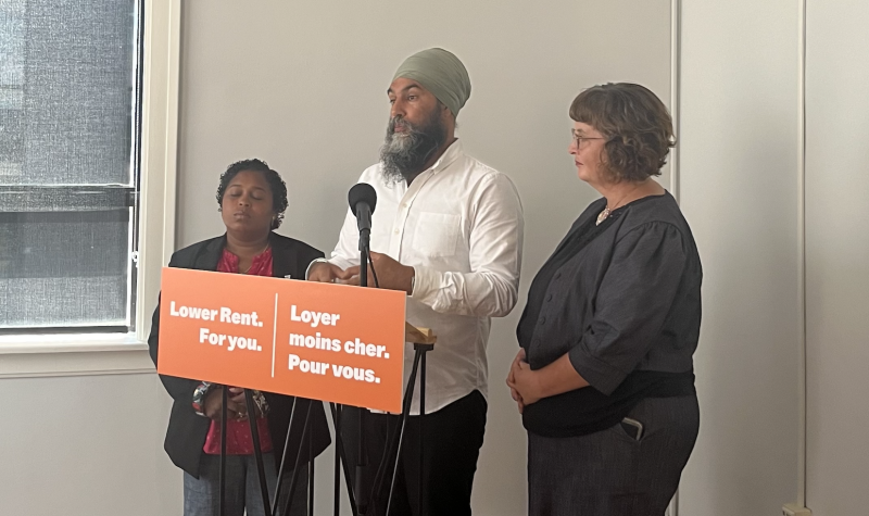 Suzy Hansen, Jagmeet Singh and Lisa Lachance stand at podium that reads 