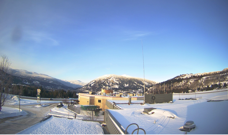 webcam photo of castlegar airport. showing snowy mountains in the background