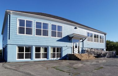 The outside of the blue Seaside Centre on a sunny day